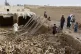 Locals inspect a damaged house following floods, landslides and thunderstorms in Kandahar province, Afghanistan, March 29, 2026