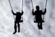 Children playing on swings in a park