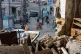 People look at a residential building damaged after a Russian drone strike in Odesa, Ukraine, March 19, 2026