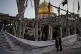 Pedestrians look at a destroyed building within the Grand Hosseiniyeh, with the mosque visible in the background, which officials at the site say was hit by US-Israeli air strikes in Zanjan, Iran, April 4, 2026