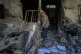 A volunteer talks on his phone while walking amid the debris of a residential building that was damaged on March 4 during the US-Israeli military campaign, in southeastern Tehran, Iran, April 14, 2026