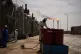 A worker collects engine oil as he works at a degassing station in Zubair oil field, whose operations have being reduced due to the Mideast war triggered by the U.S. and Israeli attacks on Iran, near Basra, Iraq, March 28, 2026