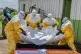 Red Cross workers carry the body of a person who died of Ebola into a coffin at a health center in Rwampara, Congo, May 20, 2026