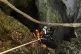 Rescuers descend into a cave in Laos, where five of seven trapped people have been rescued