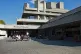 View of the front of the National Theatre with people sitting on the benches
