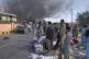 Volunteers look for victims from an overturned train coach on a railway track as survivors wait for transport at the site of bomb explosion, in Quetta, Pakistan, May 24, 2026