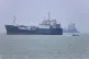 A small motorboat passes anchored vessels in the Strait of Hormuz off Bandar Abbas, Iran, June 17, 2026