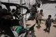 Palestinians gather around a car hit in an Israeli strike in Gaza City, June 18, 2026