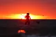 A person paddleboards at sunrise off Tynemouth Beach in the north east of England, June 23, 2026