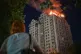 A woman looks at a block of flats burning after a Russian missile attack in Kyiv, Ukraine, July 2, 2026