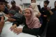 Roaa Abu Jarad mourns over the body of her father Omran Abu Jarad, 48, who was killed in an Israeli military strike, during his funeral at Al-Shifa Hospital in Gaza City, July 7, 2026