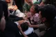 Jana, 8, mourns over the body of her 10-year-old brother, Motaz Abu Shaar, who was killed by the Israeli military, during his funeral at Nasser Hospital in Khan Younis, southern Gaza Strip, July 14, 2026