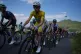 Slovenia's Tadej Pogacar, wearing the overall leader's yellow jersey, rides in the pack during the tenth stage of the Tour de France cycling race with start in Aurillac and finish in Le Lioran, France, July 14, 2026