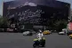Vehicles drive past a billboard depicting US President Donald Trump lying on what appears to be a coffin and bearing anti-Trump messages, including the phrase ‘We Kill Trump,’ at Islamic Revolution Square in downtown Tehran, Iran, July 15, 2026