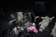 A Palestinian woman saves belongings from her home which was destroyed by an Israeli air strike last night, at al-Bureij refugee camp, central Gaza Strip, July 16, 2026