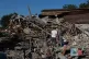 A family stands on ruins of their home after a Russian air guided bomb hit their private house in Zaporizhzhia, Ukraine
