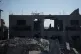 A Palestinian woman inspects a destroyed building following an Israeli airstrike in Deir al-Balah, central Gaza Strip, on Sunday