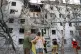 Residents look at their ruined home following a Russian air guided bomb strike in Zaporizhzhia, Ukraine, July 19, 2026