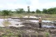 Martha Waema, stands on her farm after it was submerged by weeks of rainfall in Machakos, Kenya, May 8, 2024