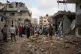 Palestinians inspect destroyed buildings at the site of an Israeli air strike, at al-Maghazi refugee camp, Gaza, July 24, 2026