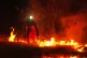 Firefighters use controlled burning to halt a wildfire that continues to spread near Cebreros, Ávila province, Spain, July 28, 2026