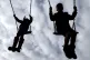 Children enjoy playing on swings in a park near Ashford, Kent