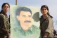 Kurdish soliders hold a portrait of imprisoned freedom fight