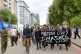 Campagners from CAAT make their way to stage a ‘die-in’ 