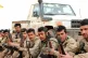 Kurdish YPG fighters sit by a truck somewhere in Syria