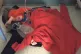 Four-year-old Jack Williment-Barr lies on a pile of coats wh