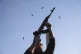 An opposition fighter fires his AK-47 in the air in celebrat
