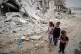 NO SAFE ZONES: Children walk by the destroyed house of journ