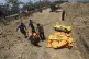 Indonesian police carry the body of a tsunami victim during 