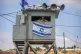 An Israeli soldier stands guard at the Tapuach junction next