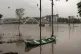 A boat is seen anchored to a pole after the Periyar river ov