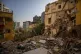 Damaged buildings are seen in a neighbourhood near the site 
