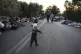 A boy tries to stand as migrants sleep on the road near the 