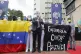 Opposition leader Juan Guaido, center, joins health workers 