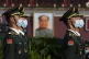 Chinese honour guards are seen near the portrait of Mao Zedo