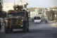 Turkish military convoy drives through the village of Urum a