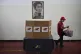 A woman walks past an image of the Venezuelan independence h