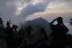 People take photos of the sunset from the top of the El Avil