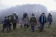 two Afghan families walk in a clearing after leaving a Croat