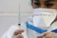 A nurse prepares a syringe with the COVID-19 vaccine at Sant