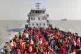 Rohingya refugees travel in a naval ship to be transported t