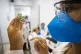 A nurse assistant prepares a dose of the Oxford-AstraZeneca 