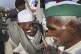 Elderly farmers talk on a heavily barricaded road along one 