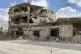 A building damaged by Syrian government forces following cla