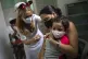 A mother holds her daughter who is injected with a dose of t