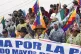 Bolivia's President Luis Arce (centre) waves as he walks wit